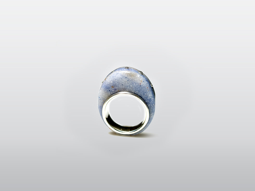 Sterling Silver Ring encircling blue Corian